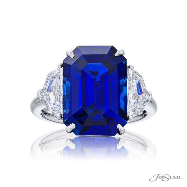 Sapphire and diamond ring featuring a 11.63 ct. emerald-cut sapphire embraced by two matching diamonds. 0283-096