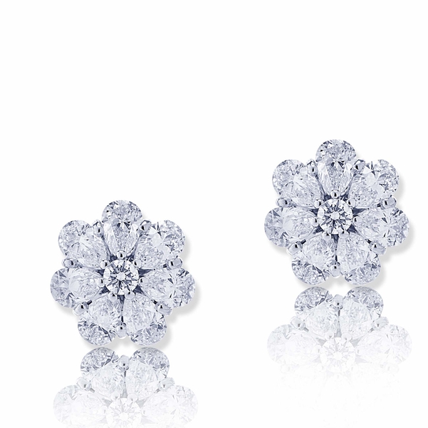 Beautiful diamond stud earrings featuring pear shape and round diamonds..jpg