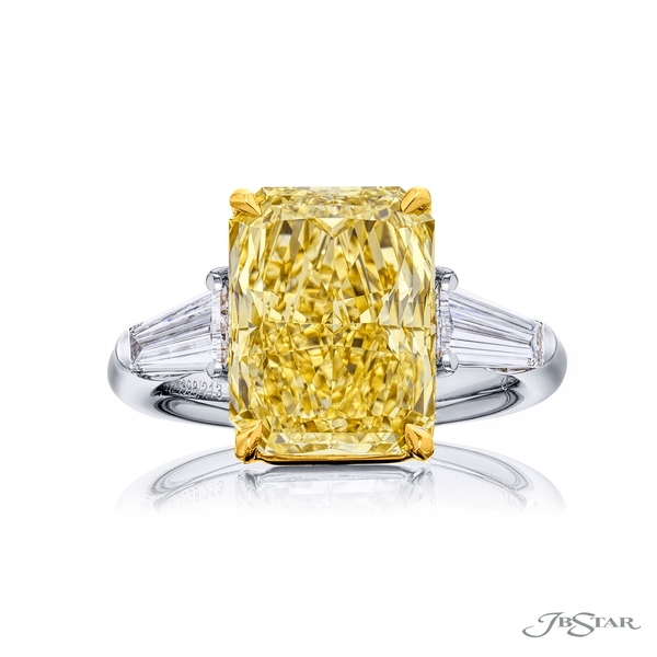 5.96 ct. GIA certified radiant cut fancy yellow diamond center embraced between two tapered baguette diamonds. 4398-213