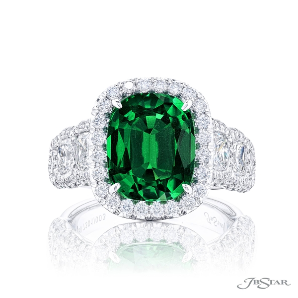 Emerald and diamond ring featuring a 5.08 ct. cushion-cut emerald center embraced by cushion-cut diamonds in a micro pave setting.7301-003