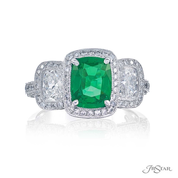 Emerald and diamond ring featuring a 1.31 ct. cushion-cut emerald embraced by two cushion-cut diamonds in a micro pave setting. 1377-001
