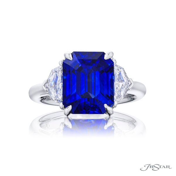 Sapphire and diamond ring featuring a 7.27 ct. emerald-cut sapphire embraced by two matching diamonds.0283-093