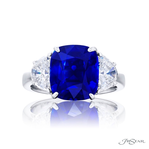 Sapphire and diamond ring featuring a 6.19 ct. cushion-cut sapphire embraced between two half moon diamonds. 4664-238