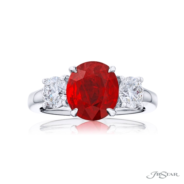 Ruby and diamond ring featuring a 3.21 ct. round ruby center embraced by two round diamonds.0913-066