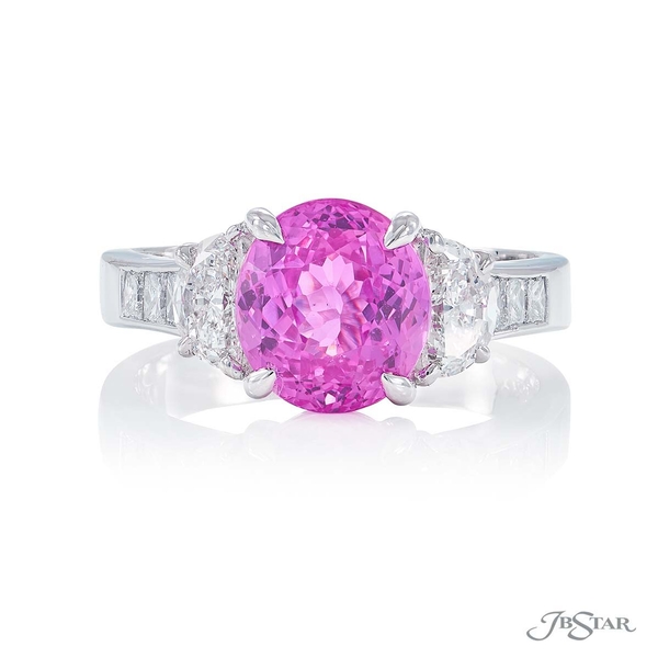 Pink sapphire and diamond ring featuring a 2.85 ct. oval pink sapphire embraced by half moon diamonds with princess cut diamonds on the shank. 1339-009
