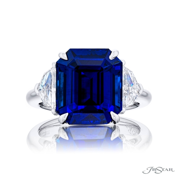 Sapphire and diamond ring featuring a 10.03 ct. certified Sri Lankan emerald-cut sapphire embraced by two matching diamonds.0283-111