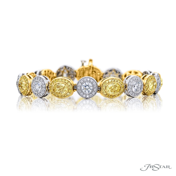 Fancy yellow diamond bracelet featuring 9 oval-cut fancy yellow diamonds linked together by round diamonds in a pave setting. 1036-003
