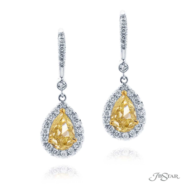 Fancy yellow diamond earrings featuring stunning 1.03 ct. GIA certified pear shaped fancy yellow diamonds embraced by round diamonds. 1631-128