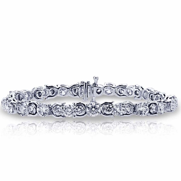 diamond bracelet featuring 44 brilliant round diamonds prong set in an intricate design.jpg