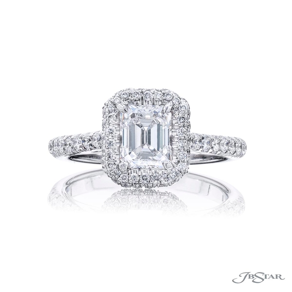 0.86 ct. GIA certified emerald-cut diamond surrounded by a halo of round diamonds. 0134-077