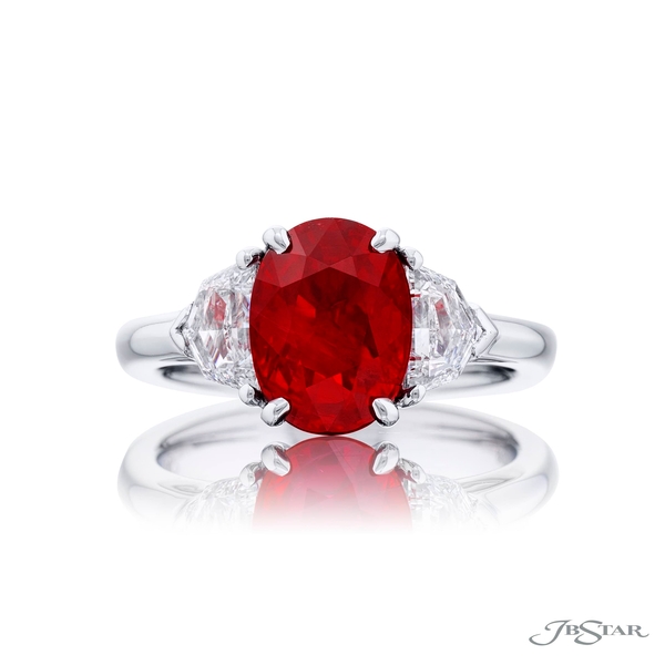 Ruby and diamond ring featuring a 3.27 ct. certified Burma oval ruby embraced by two matching diamonds. 0283-048
