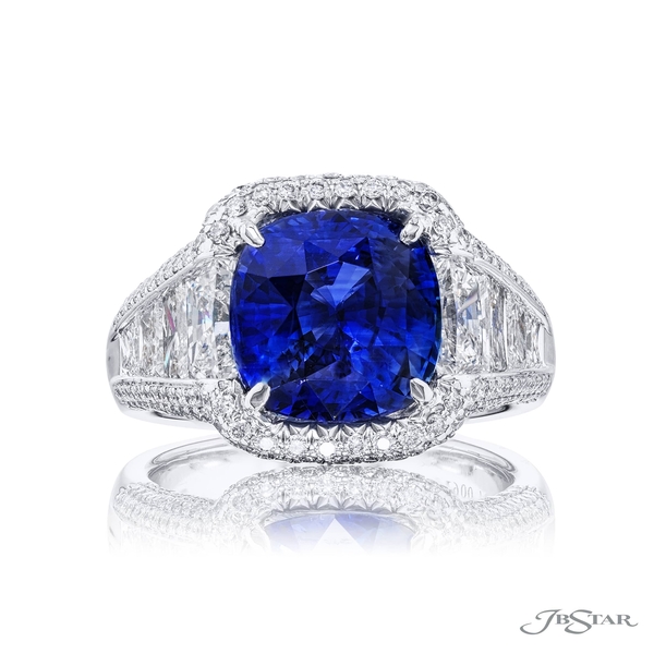 Sapphire and diamond ring featuring a 5.02 ct. certified vivid cushion-cut sapphire center embraced by trapezoid diamonds surrounded by micro pave diamonds. 7007-084